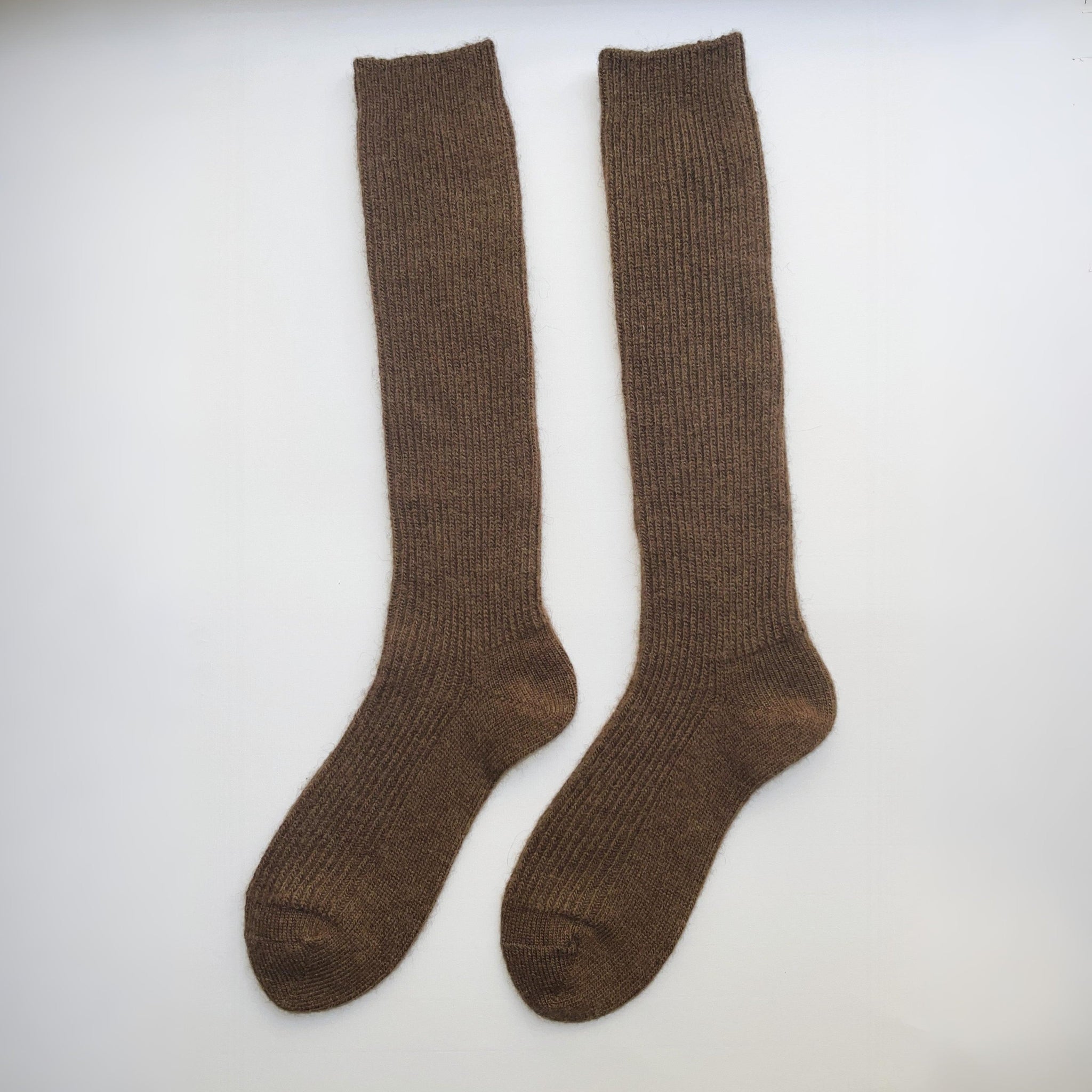 Pair of brown knee-high socks on a white background