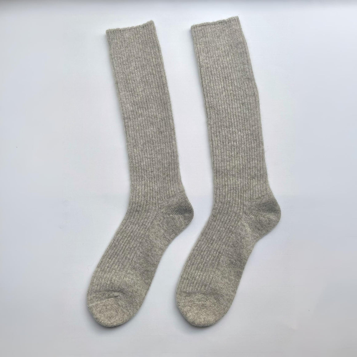 Pair of brown knee-high socks on a white background