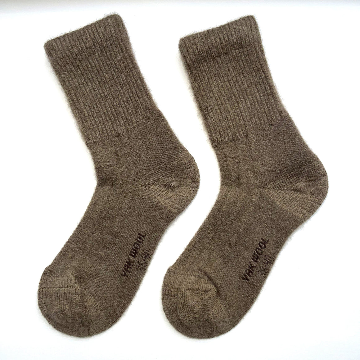 a pair of medium brown wool socks on a white background 