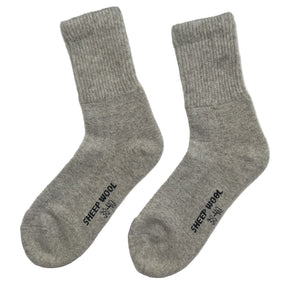 Pair of grey sheep wool socks on a white background