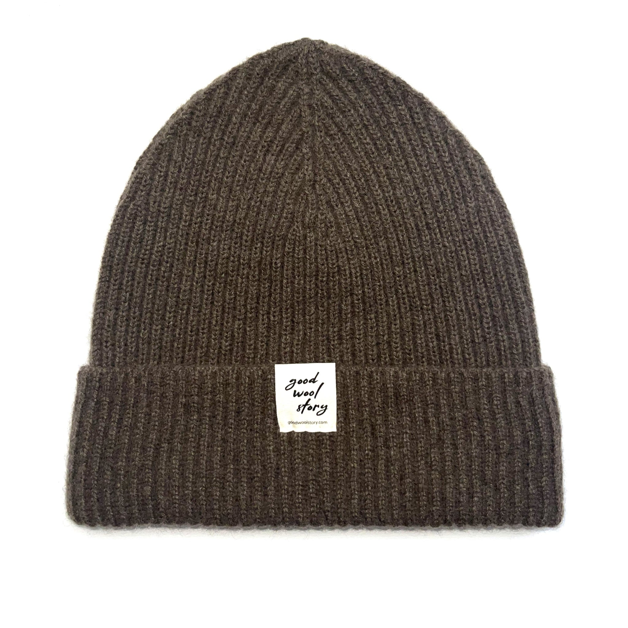Brown knit beanie with a label on a white background