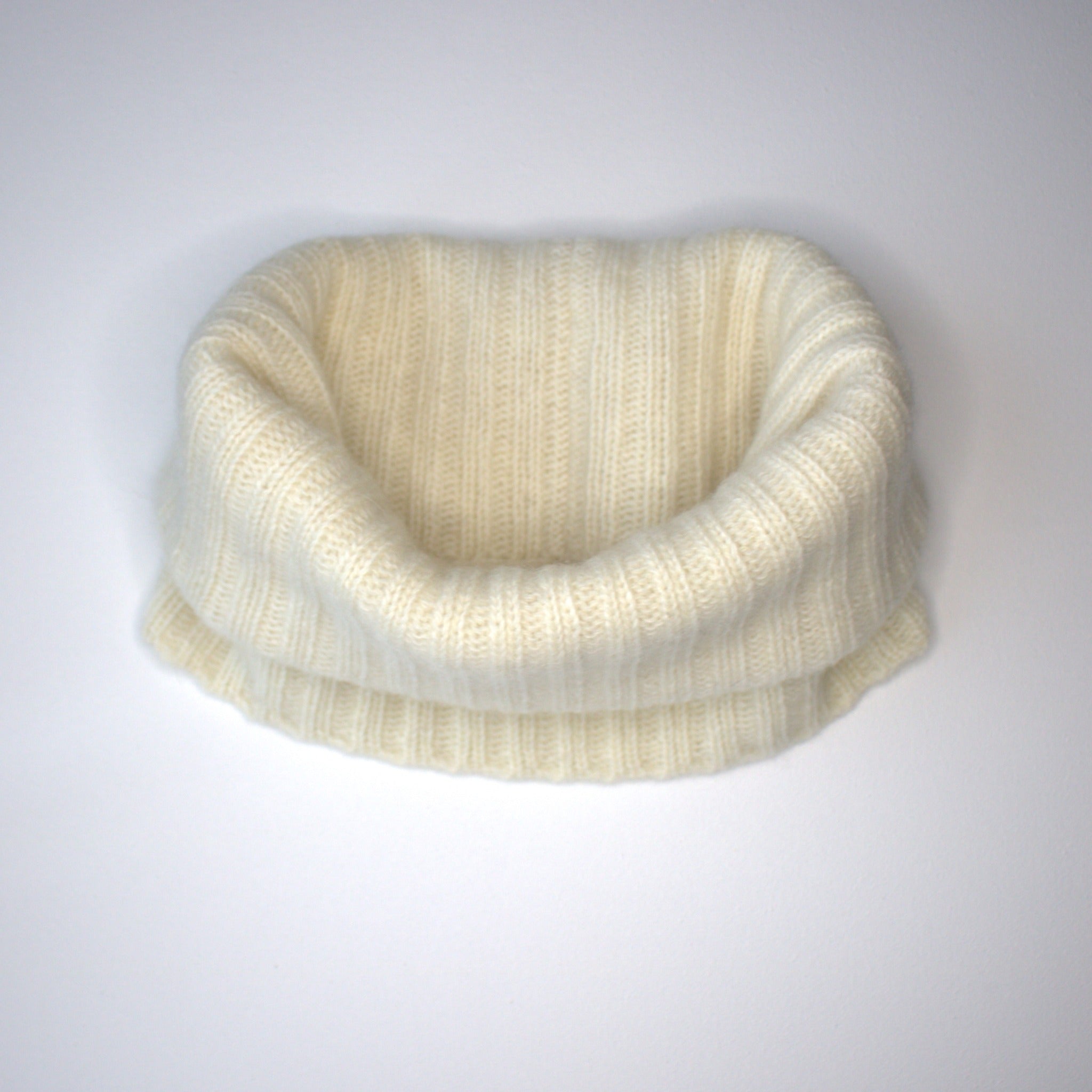 ivory white snood folded on white background