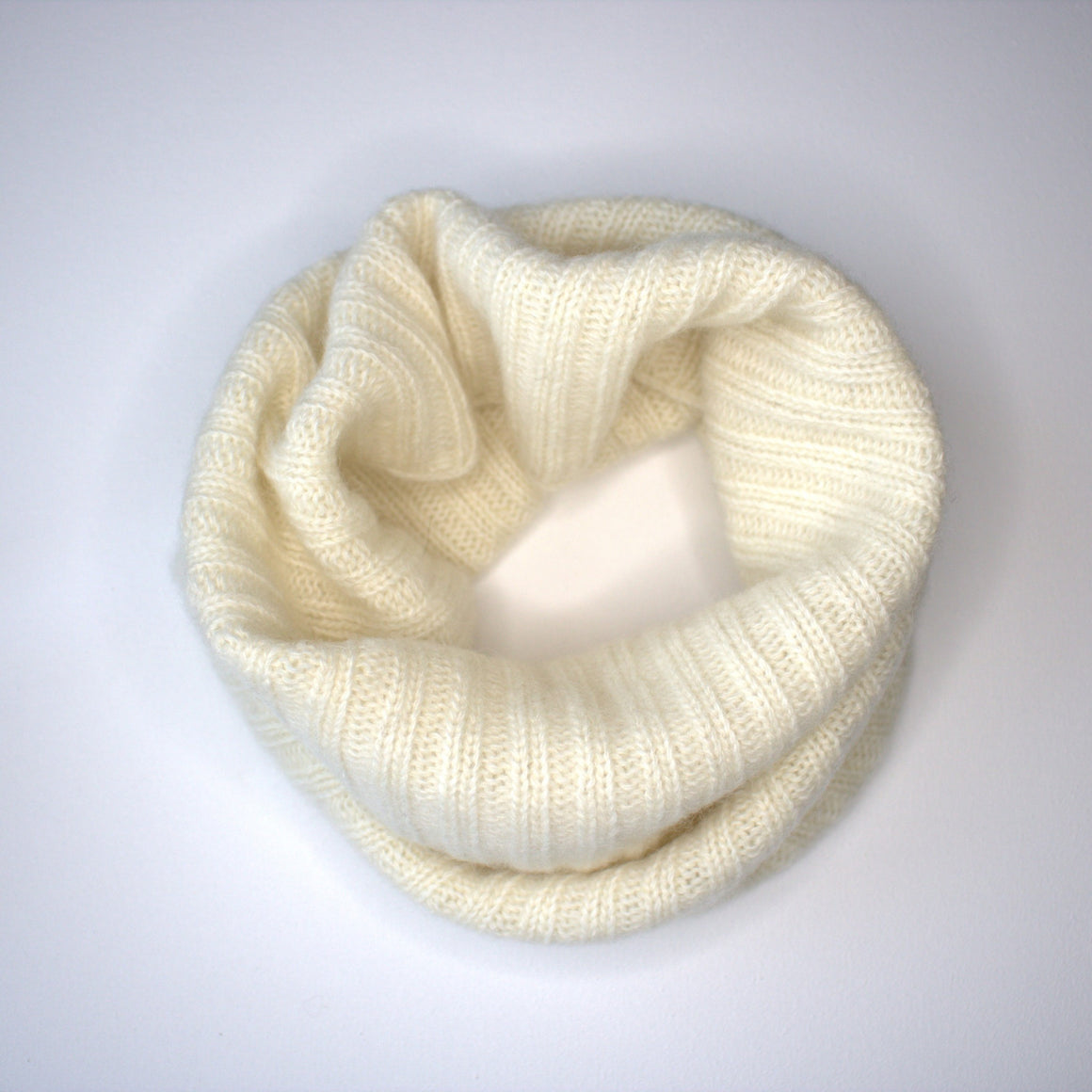 ivory white snood folded on white background