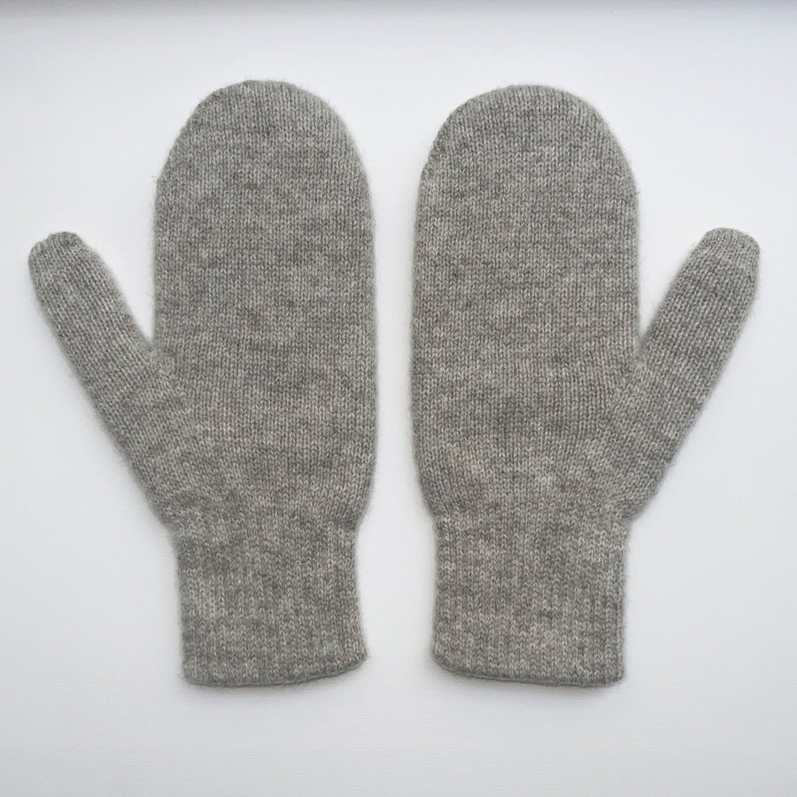 Pair of gray mittens with a label on a white background