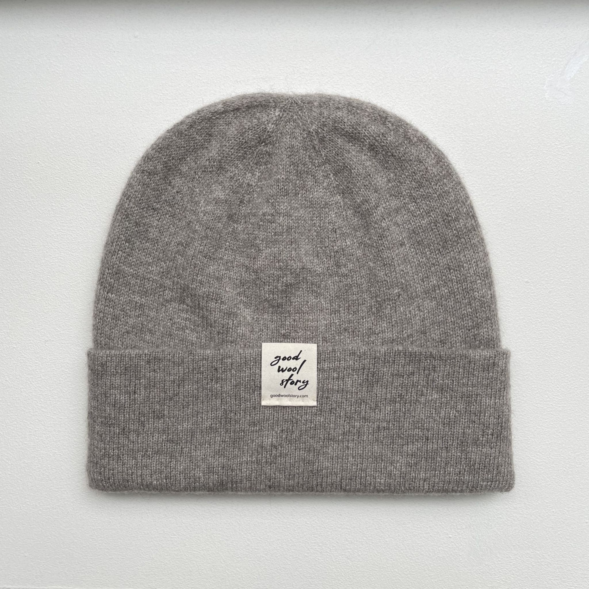 Gray beanie with a label on a black background