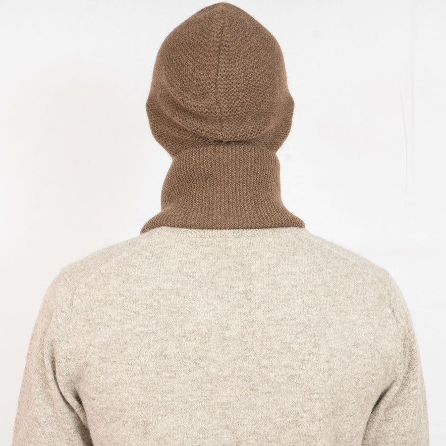 Brown knit beanie on a white background